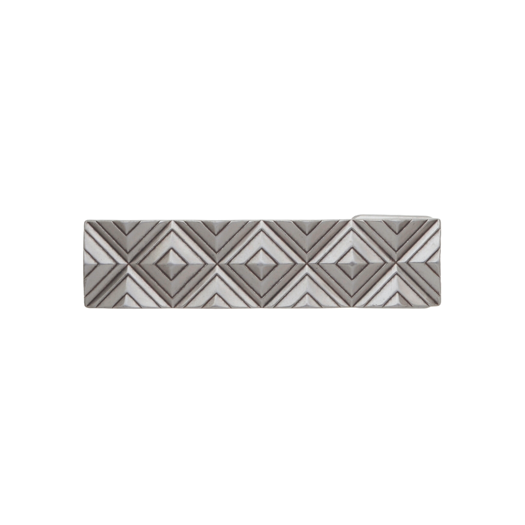 Rectangular silver-tone belt buckle with a 3D geometric diamond pattern, a modern Italian design fashion accessory.