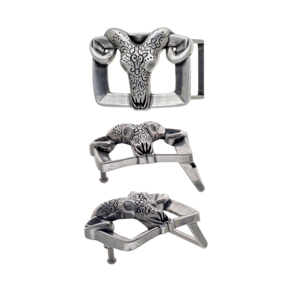 Engraved ram-skull buckle, antique silver finish with curved horns, three-quarter view showing hardware