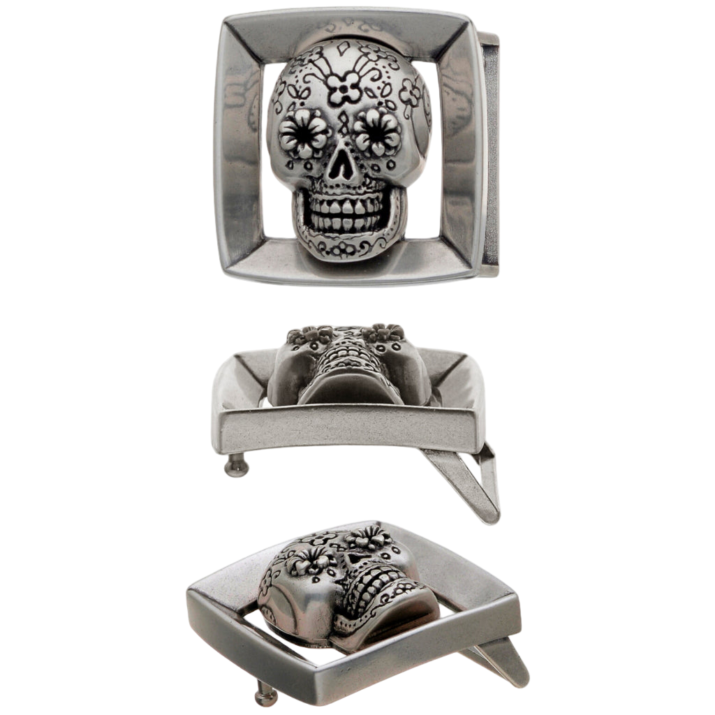 Silver belt buckle with skull design on a white background