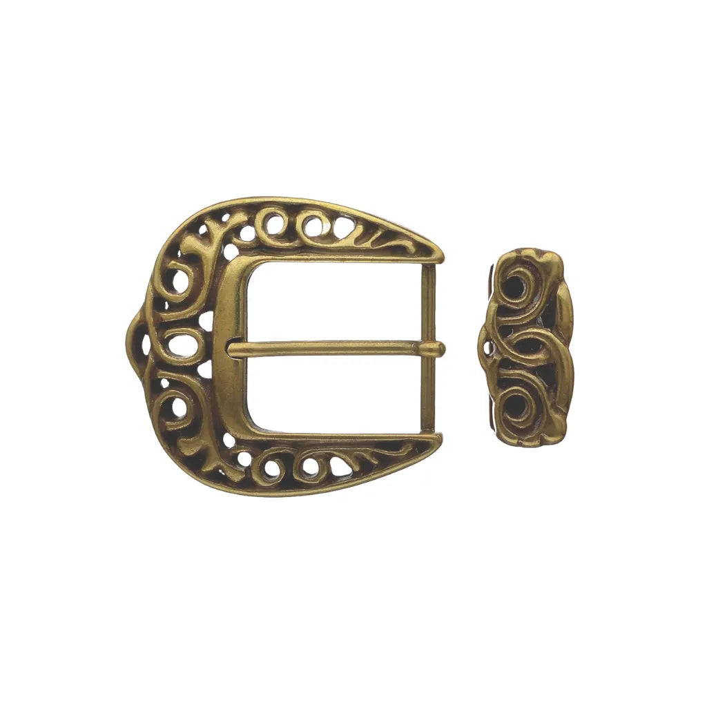 Antique brass-tone two-piece western belt buckle set featuring a rounded frame and matching keeper with intricate open-work floral filigree and scroll engraving.