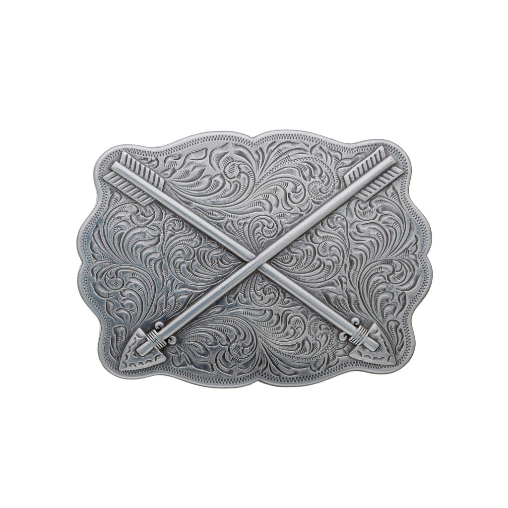 A detailed silver belt buckle with a Western design. This fashion accessory features two crossed arrows over an ornate background of scrollwork and patterns.