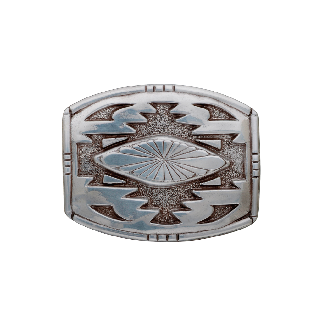 A detailed silver belt buckle with a Southwestern-style design. This fashion accessory features a central fluted pattern surrounded by bold geometric motifs and a textured background.