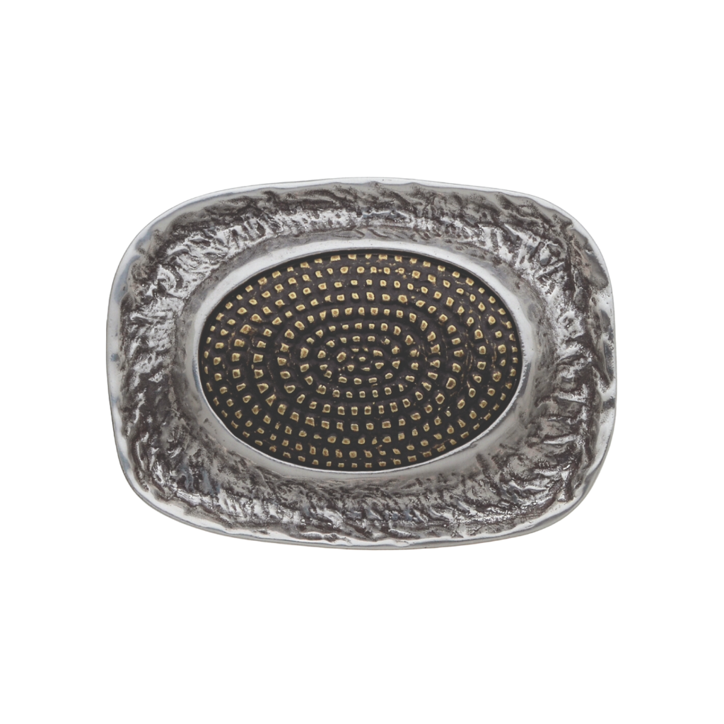 Unique rectangular silver belt buckle with a textured stone-like border and a central oval black inlay with a spiral dot design, a modern and elegant fashion accessory with an Italian design.

