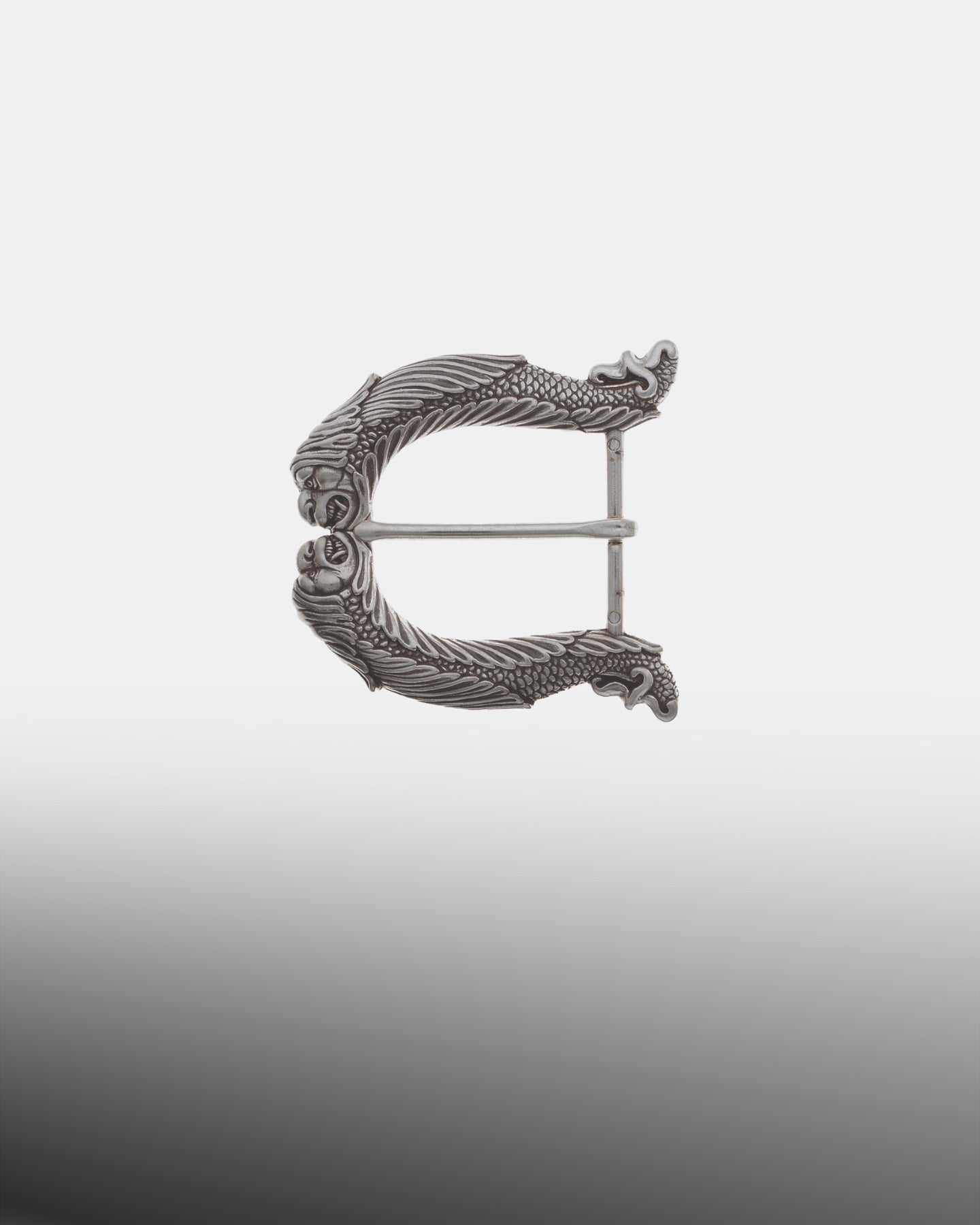 Antique silver dragon-themed belt buckle featuring two serpent-like creature heads meeting at the center with a scaled body frame and single prong.