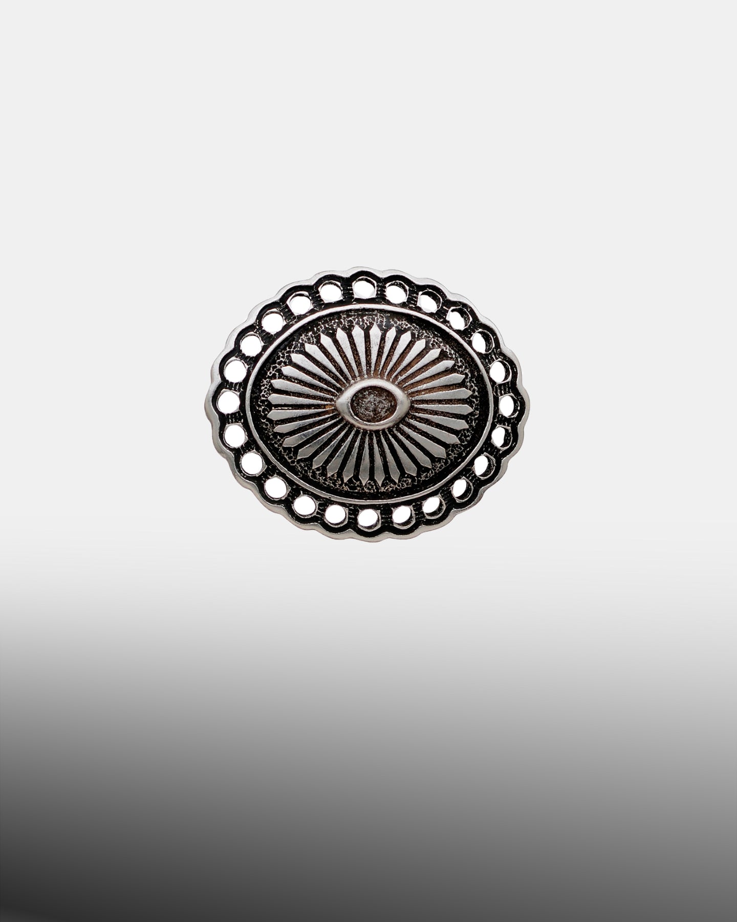 Antique silver oval sunburst concho with open-work scalloped border and etched center.