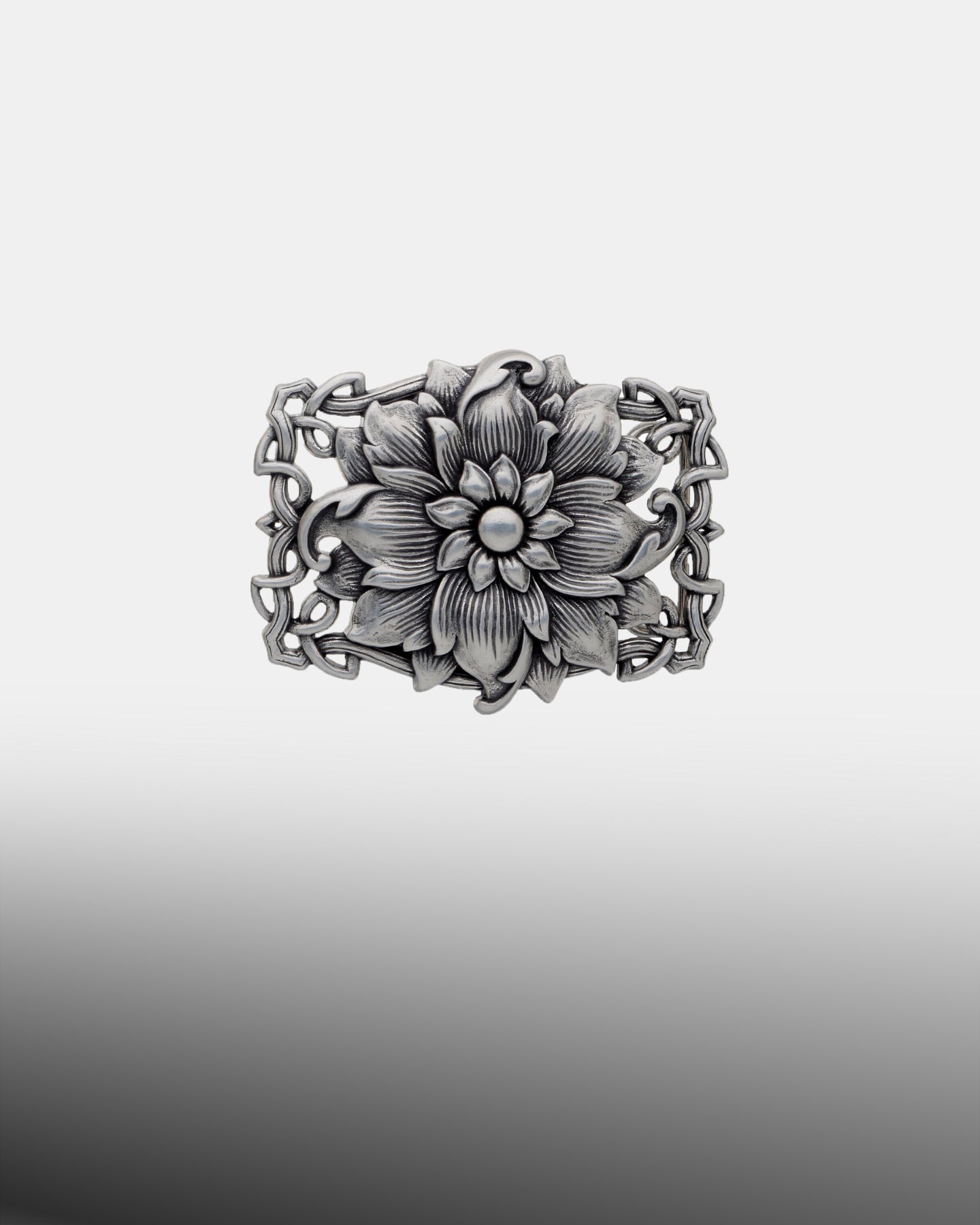 Antique silver floral belt buckle with large blooming flower and ornate scrollwork border.